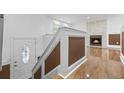 Staircase and living room with beautiful hardwood floors and stone fireplace at 5250 Forest Downs Ln, Atlanta, GA 30349