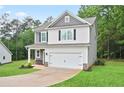 Charming two-story home featuring a two-car garage and a well manicured lawn at 130 Bingley Ct, Covington, GA 30016