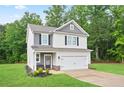 Charming two-story home features a two-car garage and a well manicured lawn at 130 Bingley Ct, Covington, GA 30016