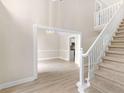 Elegant foyer features a staircase and entry into the dining room and kitchen with hardwood floors at 30 Stonewall Dr, Covington, GA 30016