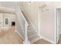 Bright foyer showcasing a staircase leading to an open floorplan and living area with fireplace at 30 Stonewall Dr, Covington, GA 30016