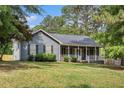 Well-manicured lawn accentuates this single Gathering home with a covered front porch at 325 N Oakland Cir, Mcdonough, GA 30253