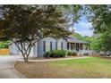 Single story home featuring a long drive, well manicured lawn and covered porch at 325 N Oakland Cir, Mcdonough, GA 30253