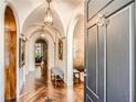 Inviting foyer with arched doorways, wood floors, and stylish lighting fixtures at 2440 Peachtree Nw Rd # 9, Atlanta, GA 30305
