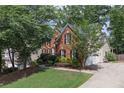 Spacious home featuring a two-car garage, brick and vinyl siding, and mature trees at 3004 High Vista Walk, Woodstock, GA 30189