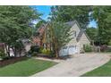 Spacious home featuring a two-car garage, brick and vinyl siding, and mature trees at 3004 High Vista Walk, Woodstock, GA 30189