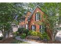 Attractive brick home with black shutters, mature trees, and manicured landscaping at 3004 High Vista Walk, Woodstock, GA 30189