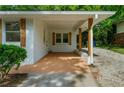 A covered carport is attached to a freshly painted home with trimmed bushes at 2385 Perkerson Sw Rd, Atlanta, GA 30315