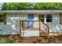 A charming updated front porch with new railings and a freshly painted blue front door at 2385 Perkerson Sw Rd, Atlanta, GA 30315