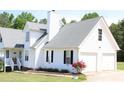 Bright two-car garage with white siding and a well-maintained lawn at 287 Diamond Ct, Carrollton, GA 30116