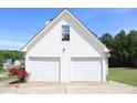 Spacious two-car garage with matching siding and a well-manicured lawn at 287 Diamond Ct, Carrollton, GA 30116