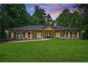 Inviting single-story home with a well-manicured lawn and attractive landscaping at 140 Emily Sw Dr, Lilburn, GA 30047