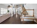 Open-concept living area with hardwood floors, staircase, neutral tones, and plenty of natural light at 1887 Chamdun Pl, Brookhaven, GA 30341