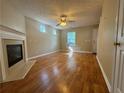 Open living space showcasing hardwood floors, a cozy fireplace, and neutral walls at 218 Osmanthus Way, Canton, GA 30114