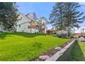Beautifully landscaped front yard with lush green grass and colorful flower beds at 3412 Collier Nw Dr, Atlanta, GA 30331