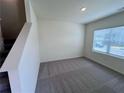 Cozy bedroom features neutral carpeting and a window bringing in natural light at 7791 Sudbury Cir, Covington, GA 30014