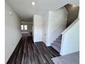 View of the entryway featuring hardwood flooring, white walls, and a staircase at 7791 Sudbury Cir, Covington, GA 30014