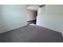 Living room area with neutral carpeting and white walls at 7791 Sudbury Cir, Covington, GA 30014