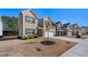 Attractive residence features a two-car garage, green lawn, and traditional design in a suburban setting at 1452 Weatherbrook Cir, Lawrenceville, GA 30043
