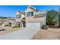 Modern two-story home showcasing a wide driveway, well-maintained lawn, and inviting curb appeal at 1452 Weatherbrook Cir, Lawrenceville, GA 30043