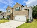 Beautiful two-story home featuring brick and siding, a manicured lawn, and an attached garage at 1452 Weatherbrook Cir, Lawrenceville, GA 30043
