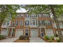 Attractive brick townhome featuring a one-car garage and well-manicured landscaping that enhances its curb appeal at 2160 Dillard Xing, Tucker, GA 30084