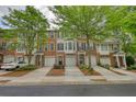 Attractive brick townhome featuring a one-car garage and well-manicured landscaping that enhances its curb appeal at 2160 Dillard Xing, Tucker, GA 30084