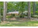 Secluded brick home nestled amongst mature trees providing privacy and a sense of tranquility at 544 W Macedonia Church Rd, Oxford, GA 30054