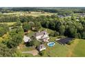 Sprawling estate boasting a grand home, backyard pool, tennis court, and guest house nestled on scenic, wooded grounds at 1481 Highway 85 Connector, Brooks, GA 30205