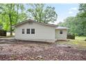 Rear exterior of the home featuring new siding and updated windows, nestled on a shady lot at 3480 Mount Olive Rd, Atlanta, GA 30344