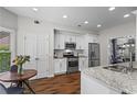 Modern kitchen featuring stainless steel appliances, granite countertops, and hardwood floors at 350 Medridge Dr, Johns Creek, GA 30022
