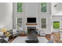 Bright living room with a fireplace, large windows, and high ceilings at 350 Medridge Dr, Johns Creek, GA 30022