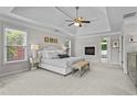 Spacious main bedroom featuring a trey ceiling, fireplace, and neutral decor at 350 Medridge Dr, Johns Creek, GA 30022