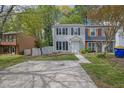Two-story townhome with a concrete driveway, lawn, and traditional architectural style at 3571 Kennesaw Station Nw Dr, Kennesaw, GA 30144