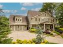 Attractive two-story home with professional landscaping, hardiplank siding, and a three car garage at 525 E Main St, Buford, GA 30518