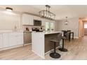 Modern kitchen boasts white cabinets, stainless steel appliances, and a stylish island with bar seating at 6914 N Baggett Rd, Douglasville, GA 30134