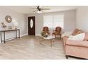 Bright living room showcases new flooring, a stylish front door, and cozy seating arrangement at 6914 N Baggett Rd, Douglasville, GA 30134