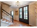 Elegant foyer featuring hardwood floors, a stylish chandelier, and a staircase with dark accents at 1590 Greyson Rdg, Marietta, GA 30062