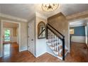 Inviting foyer with hardwood floors, staircase with black handrail, and views into adjoining rooms at 1590 Greyson Rdg, Marietta, GA 30062