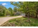 Two-story home with dormer windows, an attached garage, and a lush green lawn in a beautiful neighborhood at 165 Colony Cir, Canton, GA 30114