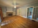 Spacious living room featuring hardwood floors, fireplace and French doors at 3366 College St, College Park, GA 30337