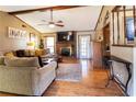 Cozy living room featuring a brick fireplace, ceiling fan, and hardwood floors at 1830 Brandy Se Ln, Conyers, GA 30013
