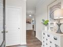 Bright foyer with a stylish cabinet and decor, leading into the home's living space with hardwood flooring at 295 Cranston Dr, Canton, GA 30114
