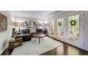 Inviting living room with hardwood floors, a comfy couch, a balcony, and stylish decor at 311 Peachtree Hills Ne Ave # 10C, Atlanta, GA 30305