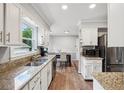 Well-lit kitchen featuring stainless steel appliances, granite countertops, and white cabinetry at 267 Somerlane Pl, Avondale Estates, GA 30002