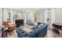 Elegant living room with hardwood floors, fireplace, and bright natural light from large windows at 267 Somerlane Pl, Avondale Estates, GA 30002