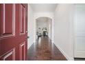 Inviting entryway with hardwood floors leading to an open-concept living space with view of fireplace at 3415 Linstead Ct, Loganville, GA 30052