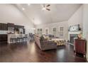 Open concept living room with hardwood floors, a fireplace, and access to kitchen and dining area at 3415 Linstead Ct, Loganville, GA 30052