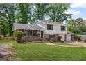 Charming two-story home with a brick and siding exterior, large front lawn, and two car garage at 6997 Vesta Brook Dr, Morrow, GA 30260