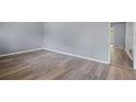 A spacious living room featuring gray walls and new hardwood flooring with natural lighting at 6997 Vesta Brook Dr, Morrow, GA 30260